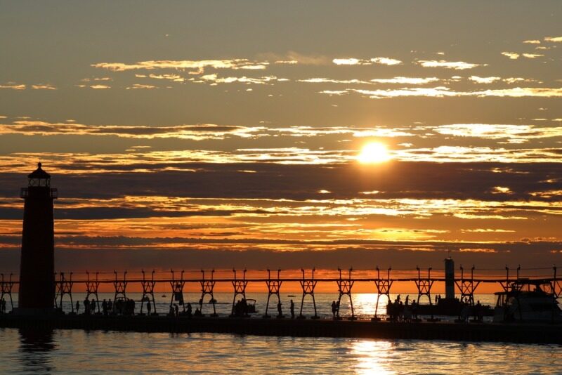 Things to Do in Grand Haven: A fall sunset over Lake Michigan in Grand Haven, MI.